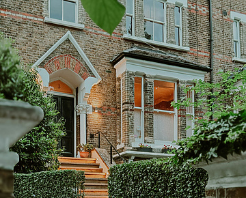 a house with stairs and a gate