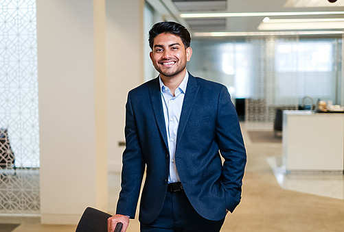 a person in a suit holding a suitcase