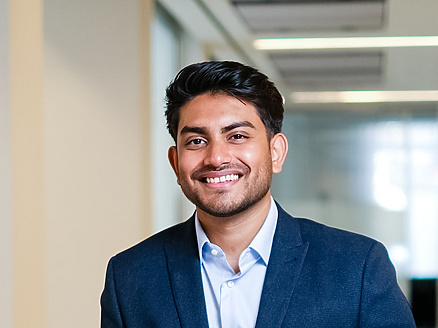 a person in a suit holding a suitcase