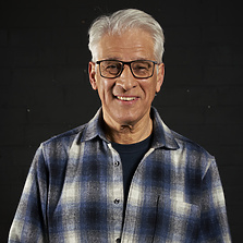 a person wearing glasses and a flannel shirt