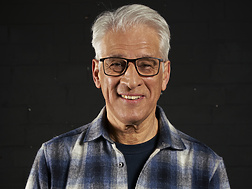 a person wearing glasses and a flannel shirt