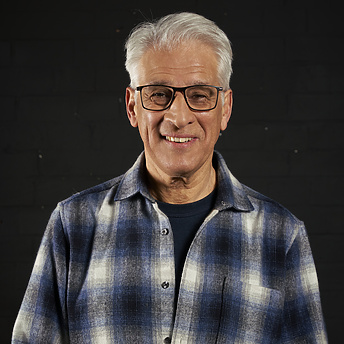 a person wearing glasses and a flannel shirt