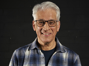 a person wearing glasses and a flannel shirt