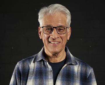 a person wearing glasses and a flannel shirt