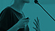Woman speaking in front of Mic