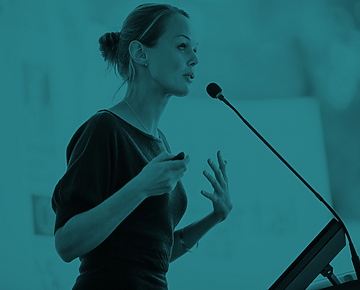 Woman speaking in front of Mic