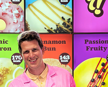 a person in pink coat holding a box of food