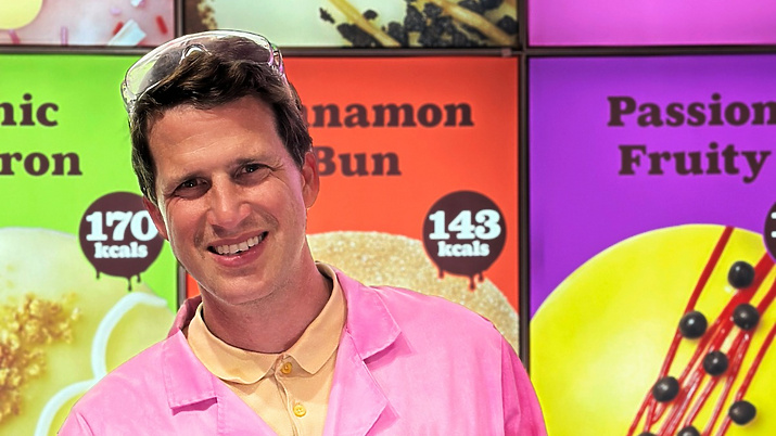 a person in pink coat holding a box of food