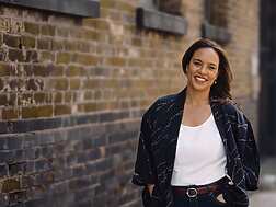 a person standing in front of a brick wall