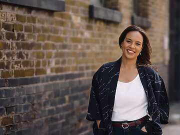 a person standing in front of a brick wall