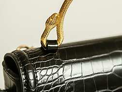 a close up of a black purse