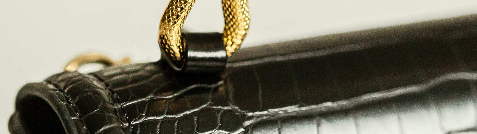 a close up of a black purse