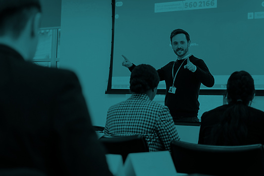 a person standing in front of a class