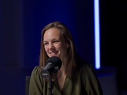 a person sitting at a microphone