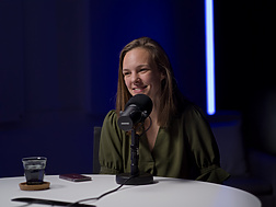 a person sitting at a microphone