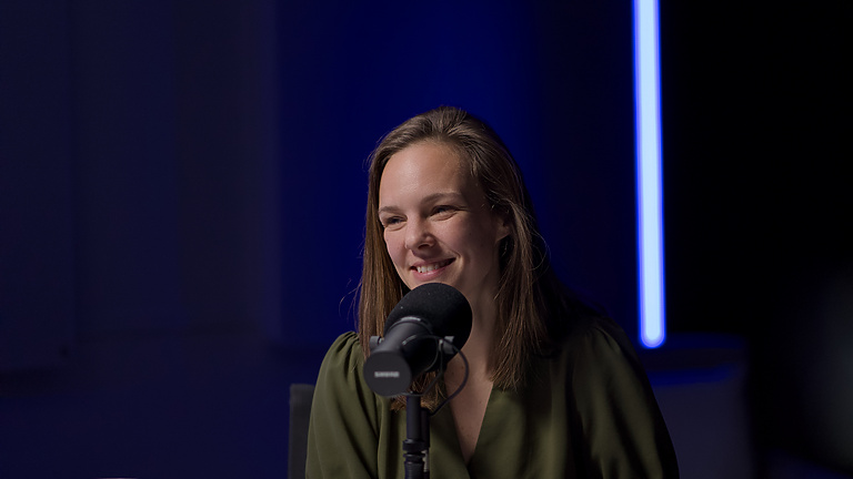 a person sitting at a microphone