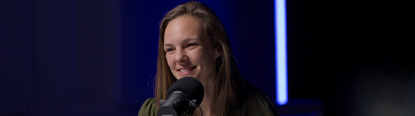 a person sitting at a microphone