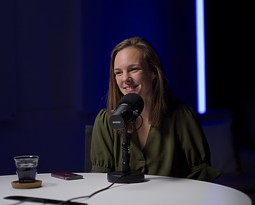 a person sitting at a microphone