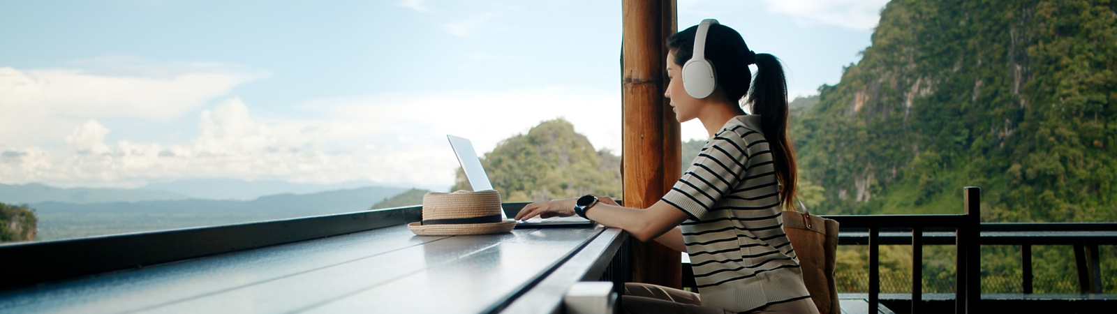 a person sitting at a table with a laptop