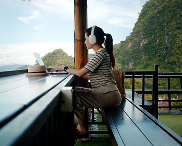 a person sitting at a table with a laptop