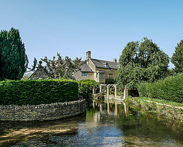 brown concrete house near river during daytime