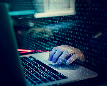 a person typing on a laptop