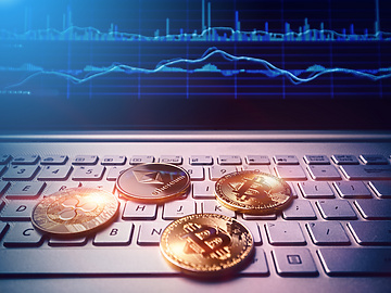 Bitcoins placed over laptop