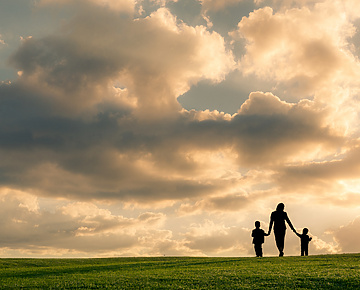 mother walking with two children