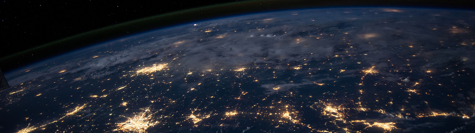 The earth from low level orbit at night featuring many illuminated cities