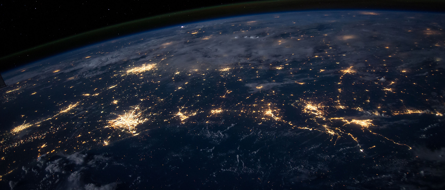 The earth from low level orbit at night featuring many illuminated cities