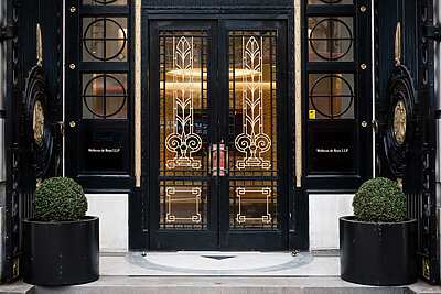a black double doors with gold designs