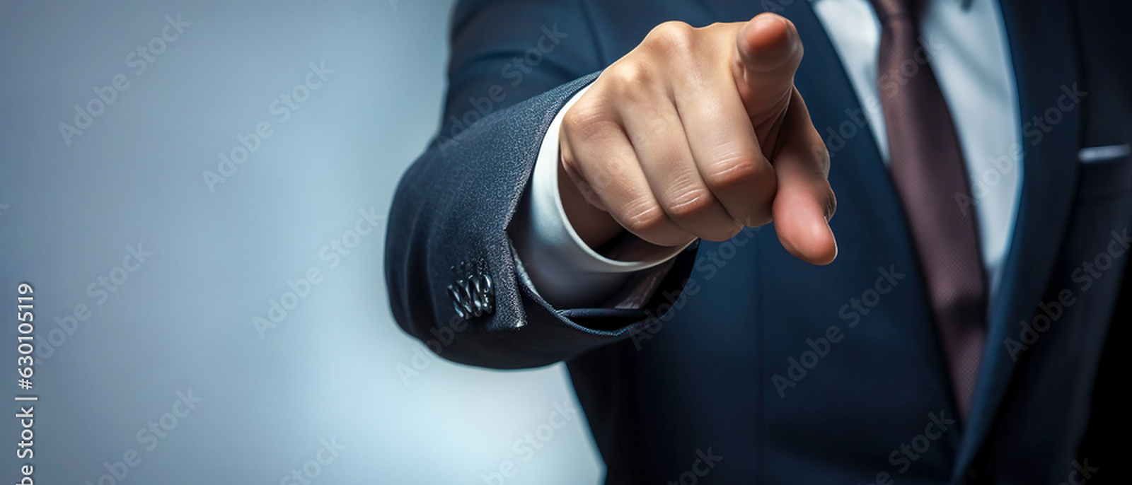 a person in a suit pointing at the camera