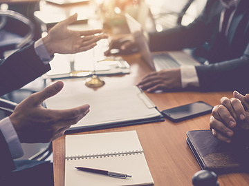 people's hands in corporate meeting