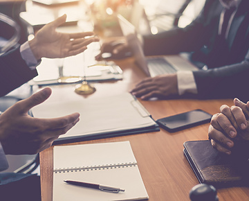 people's hands in corporate meeting