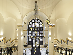a hallway with a large window and stairs