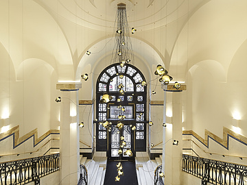 a hallway with a large window and stairs