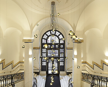 a hallway with a large window and stairs