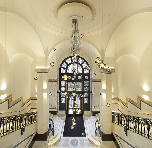 a hallway with a large window and stairs