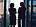 Two women talking in front of window