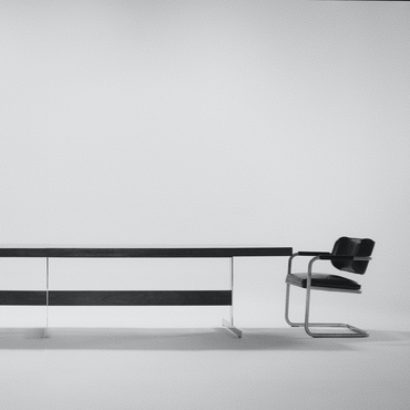 a long black bench with white walls