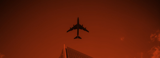 Plane flying over building