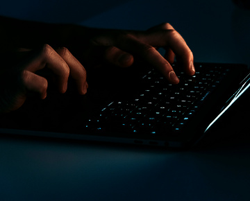 hands typing on a laptop keyboard