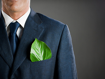 a person in a suit with a leaf in his pocket