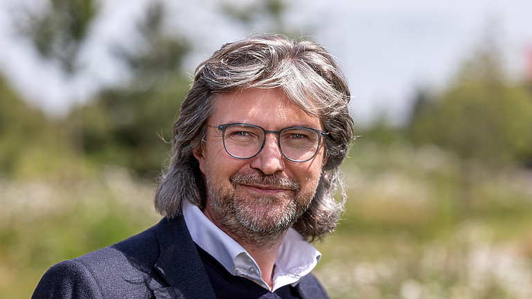 a person with glasses and a beard