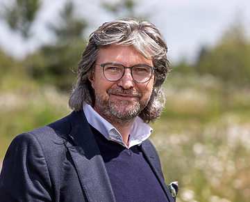 a person with glasses and a beard