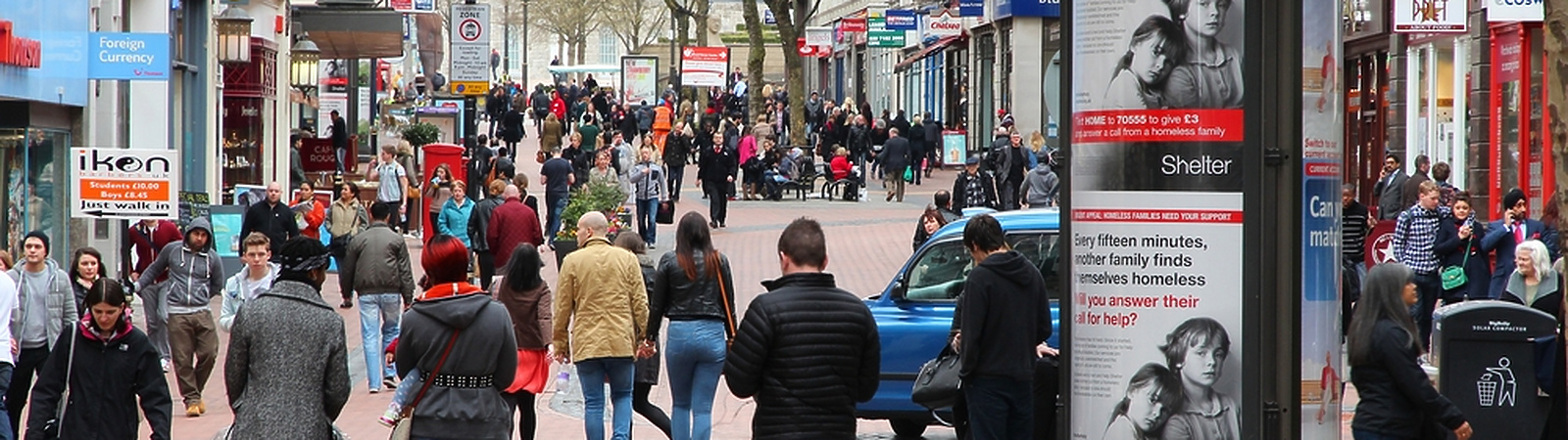 a group of people walking on a sidewalk