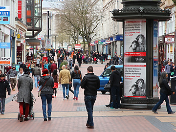 a group of people walking on a sidewalk