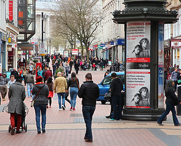 a group of people walking on a sidewalk