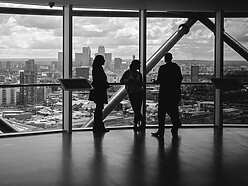 People standing at window in corporate building