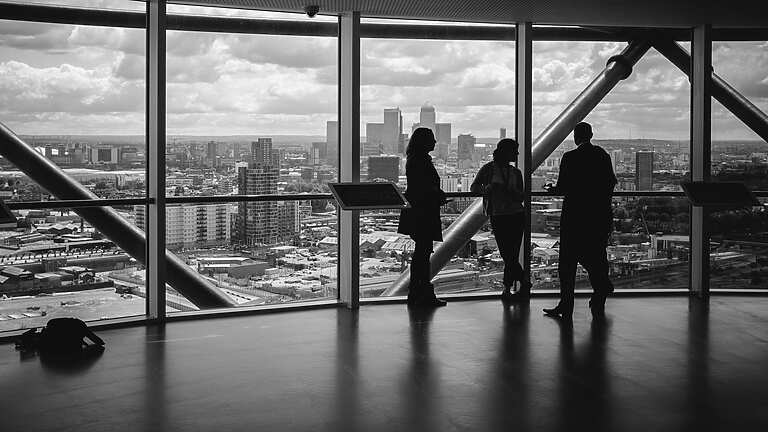 People standing at window in corporate building